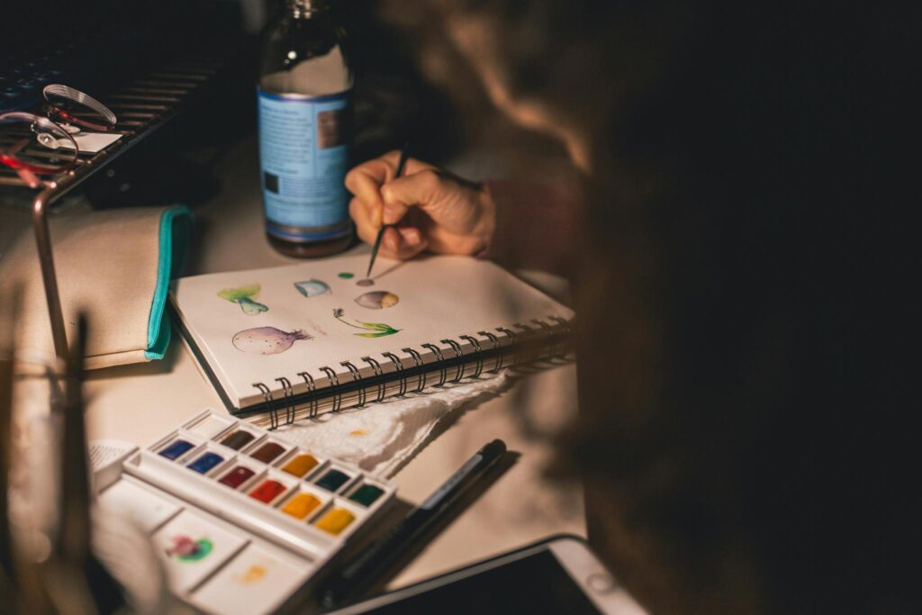 Person Writing Illustration in Spiral Notebook