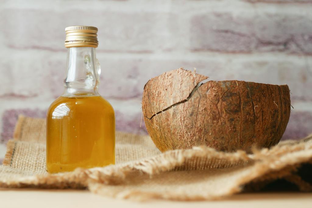 Little Bottle with Liquid and a Coconut Shell