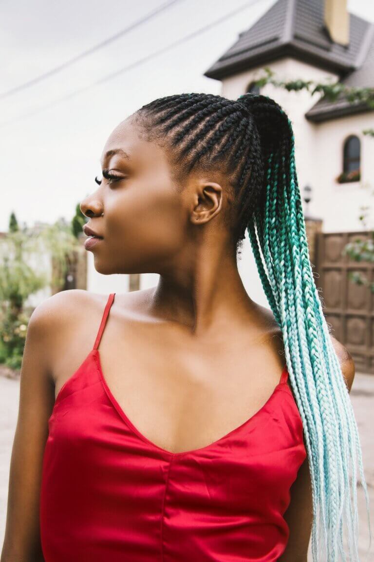 Shallow Focus Photography of Woman With Braided Hair and Wearing Red Spaghetti Strap Top