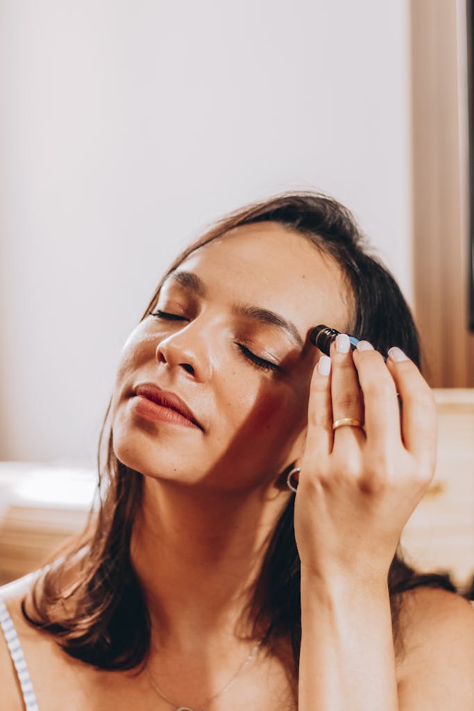 Woman Applying Beauty Product to her Face